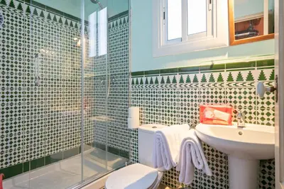 a bathroom with a sink and a toilet and a shower at Alcam Flassaders in Barcelona