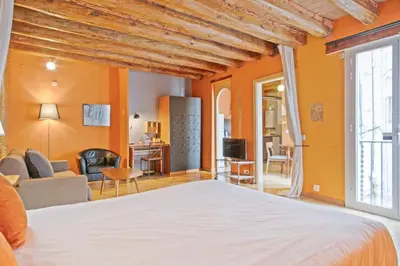 a bedroom with a bed and a living room at Alcam Flassaders in Barcelona