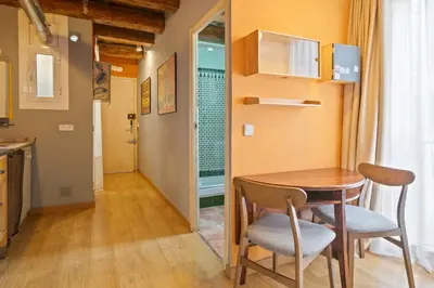 a small kitchen with a table and chairs in a room at Alcam Flassaders in Barcelona
