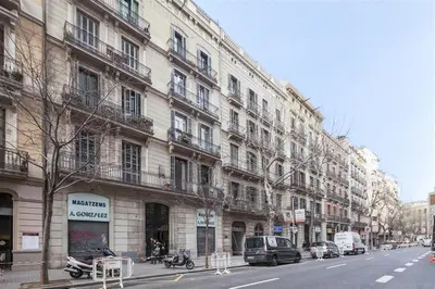 a city street with cars parked in front of buildings at Alcam Trafalgar in Barcelona