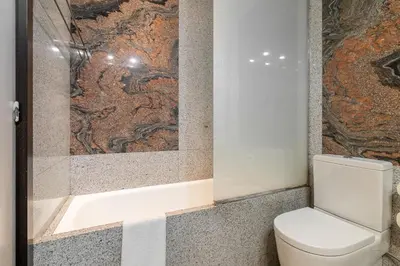 a bathroom with a toilet and a bath tub at Stay U-nique Apartments Salvador Espriu in Barcelona