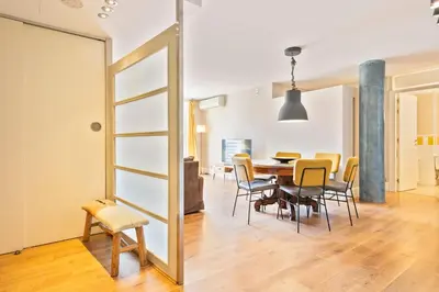 a dining room with a table and chairs and a mirror at Alcam Olimpic in Barcelona