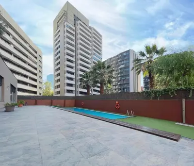 a swimming pool in a courtyard with tall buildings at Stay U-nique Apartments Venecuela in Barcelona