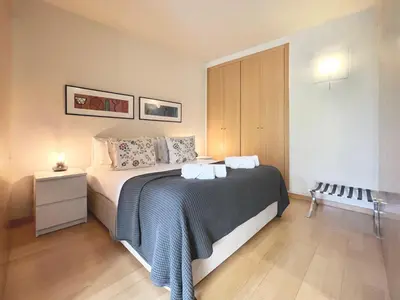 a bedroom with a large bed with a nightstand and a bed sidx sidx sidx at Stay U-nique Apartments Venecuela in Barcelona