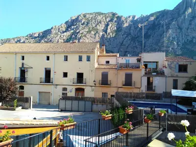 a group of buildings with a mountain in the background at Hotel Can Missé in Collbató