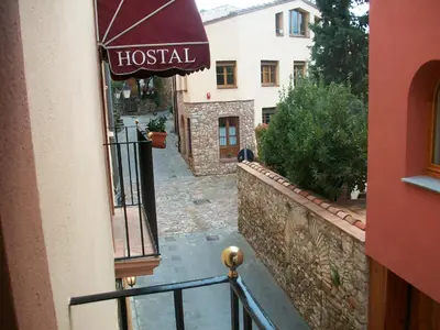 a building with a hotel sign on a balcony at Hotel Can Missé in Collbató