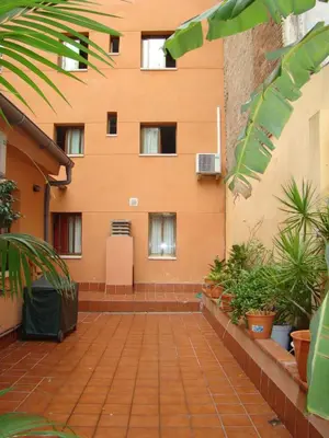 a building with a brick walkway in front of it at Hostal Baler in Barcelona