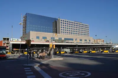 a city intersection with a building and a street with cars at Hostal Baler in Barcelona