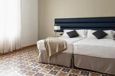 a bedroom with a large bed with a blue headboard at MH Apartments Tetuan in Barcelona