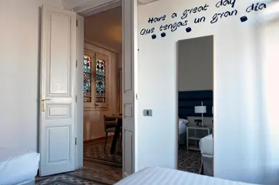 a bedroom with a door with a sign on the wall at MH Apartments Tetuan in Barcelona