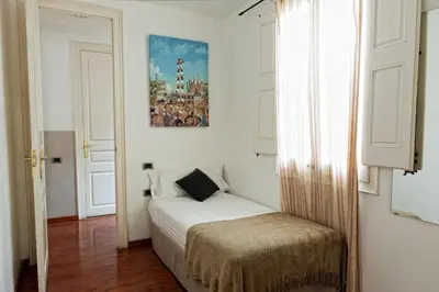 a small bedroom with a bed and a window at MH Apartments Tetuan in Barcelona