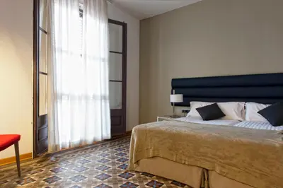a bedroom with a large bed and a large window at MH Apartments Tetuan in Barcelona
