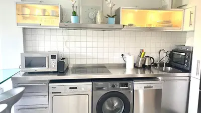 a kitchen with a washing machine and a microwave at Enric Granados 17 in Barcelona