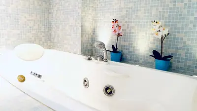 a white sink in a bathroom with blue tiles at Enric Granados 17 in Barcelona