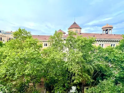 a large building with trees in front of it at Enric Granados 17 in Barcelona