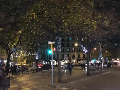 a city street at night with christmas lights on trees at Luxury Apartment Barcelona in Barcelona
