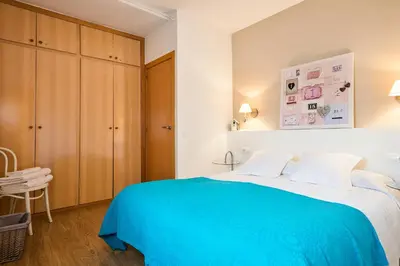 a bedroom with a blue bed and a chair at Luxury Apartment Barcelona in Barcelona