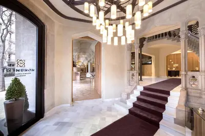 a lobby with a staircase and a chandelier at Monument Hotel in Barcelona