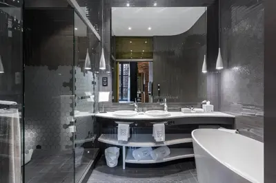 a bathroom with two sinks and a tub and a mirror at Monument Hotel in Barcelona