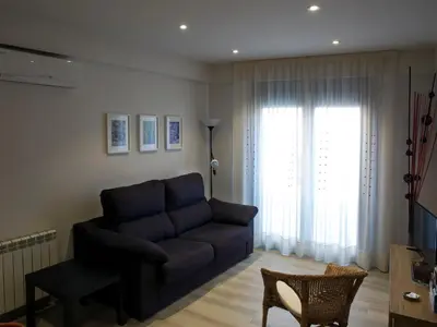 a living room with a couch and a window at Cal Negri in Vilafranca del Penedès