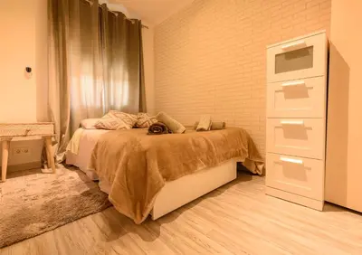 a bedroom with a bed and a dresser at Apartamento Reisol in Castelldefels