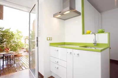a kitchen with white cabinets and a green sink at Best deal PENTHOUSE! in Barcelona