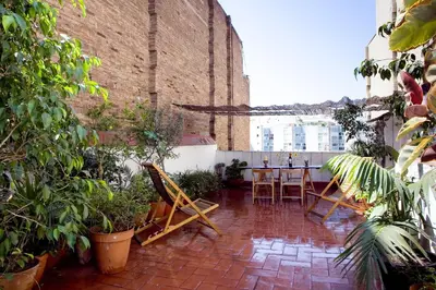a patio with a table and chairs and plants at Best deal PENTHOUSE! in Barcelona