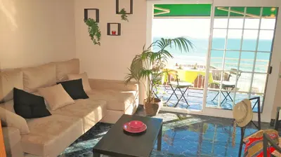 a living room with a couch and a view of the ocean at Bianca Seaview & Beach Apartment in Montgat