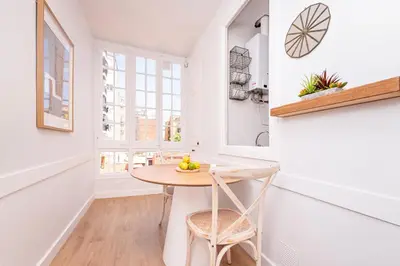 a dining room with a table and a chair at Sweett - Rosemarine in Barcelona