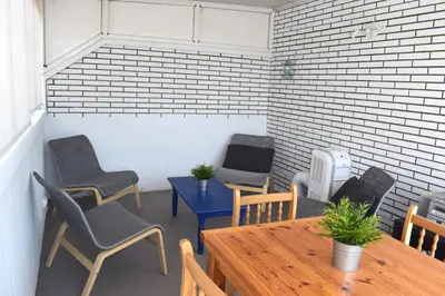 a room with chairs and a table and a desk and chairs at Duplex Berlin 87 in Barcelona