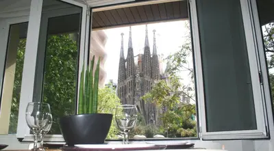 a window with a view of a large cathedral at Apartment Carrer Lepant in Barcelona
