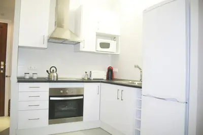 an empty hallway with white walls and white tile floors at Apartment Carrer Lepant in Barcelona