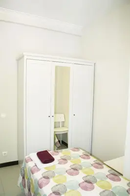 a white table with two stools in a room at Apartment Carrer Lepant in Barcelona
