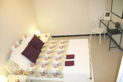 a small bedroom with a bed with a white bedspread at Apartment Carrer Lepant in Barcelona