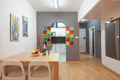 a kitchen and dining room with a table and chairs at Deep Purple in Barcelona