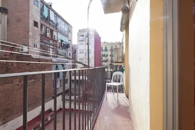 a balcony with a white chair on a building at Deep Purple in Barcelona
