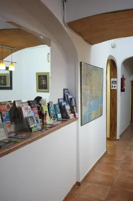 a display of books on a shelf in a room at Hostal Europa in Barcelona