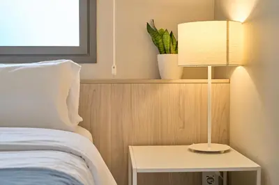 a bedroom with a bed and a table with a lamp at Hotel Omnium in Barcelona