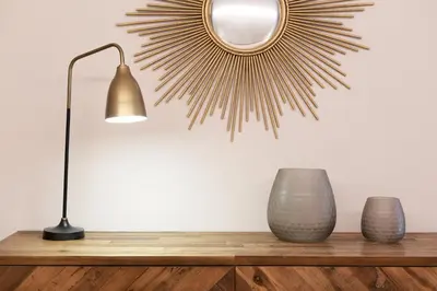 a table with a lamp and a mirror on a wall at Hotel Omnium in Barcelona