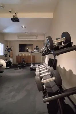 a gym with a row of treadmills at Hotel Omnium in Barcelona