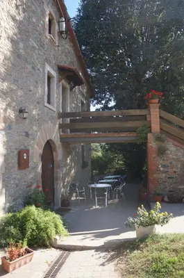 an outdoor patio with a table and a building at Can Marc in Sant Esteve de Palautordera