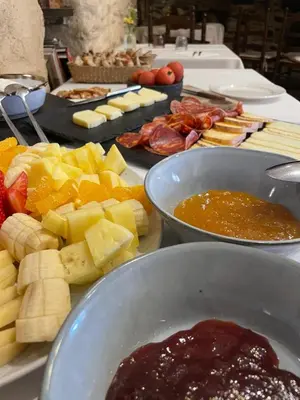 a table topped with bowls of fruit and other food at Can Marc in Sant Esteve de Palautordera