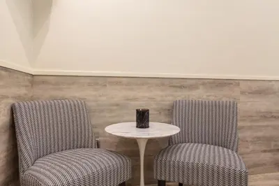 two chairs and a table with a vase on it at Hostal Oliva in Barcelona
