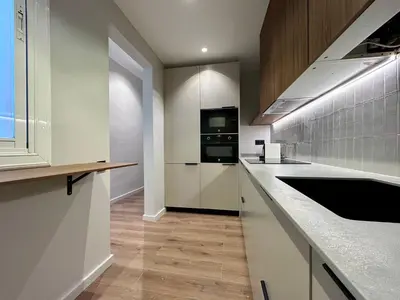 a kitchen with white cabinets and a stove top oven at BarcelonaForRent Plaza Sagrada Familia in Barcelona
