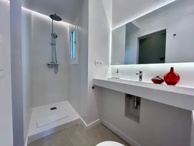 a white bathroom with a sink and a mirror at BarcelonaForRent Plaza Sagrada Familia in Barcelona