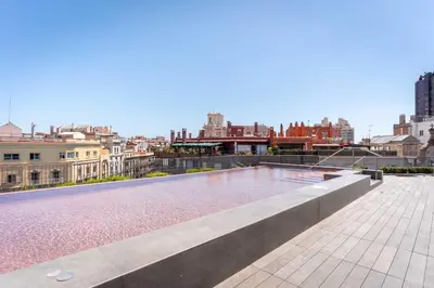 a swimming pool on the roof of a building at Midtown Apartments in Barcelona