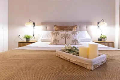 a bedroom with a large bed with two candles on it at Gran apartamento Sagrada Familia in Barcelona