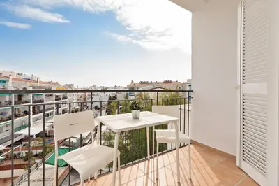 a balcony with a table and chairs and a view at Sitges Group Soul in Sitges