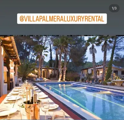 a swimming pool with tables and chairs next to a house at Villa Palmera in Olivella