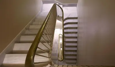 a spiral staircase with a metal handrail in a building at Duquesa Suites Landmark Hotel by Grup Duquessa in Barcelona